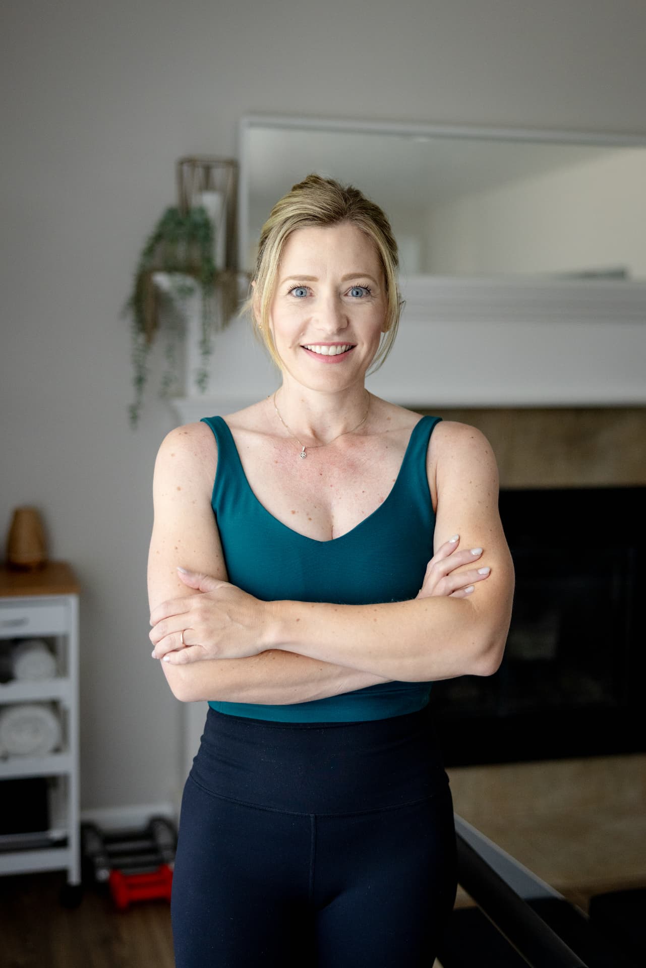 Leah Alvarez standing with her arms crossed in the Privata Pilates studio